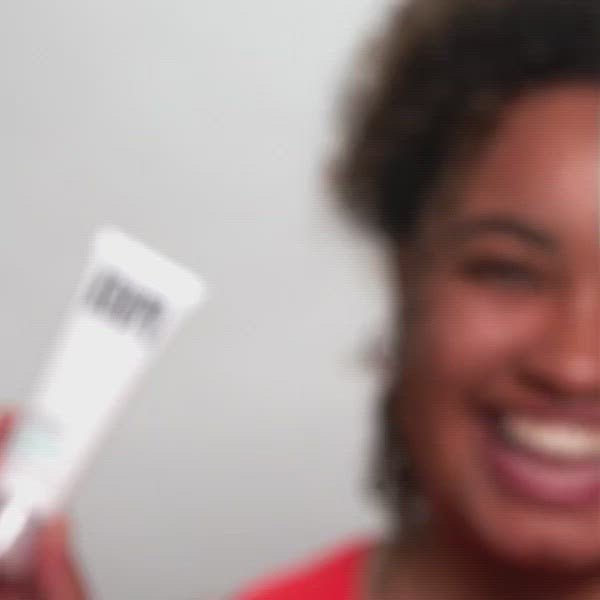 A smiling woman holds a koope product