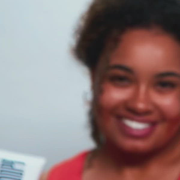 A smiling woman holds a koope product